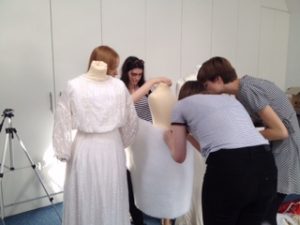 hitchin girlsschool pupils practising padding the mannequins for display